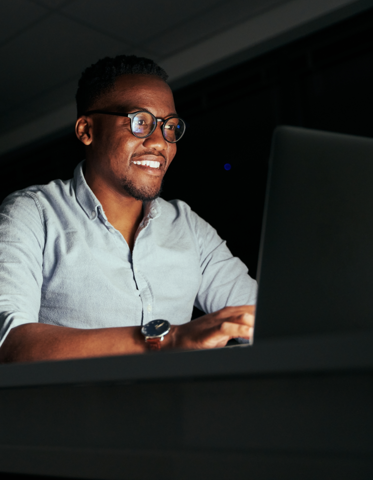 man in office at desk looking at computer