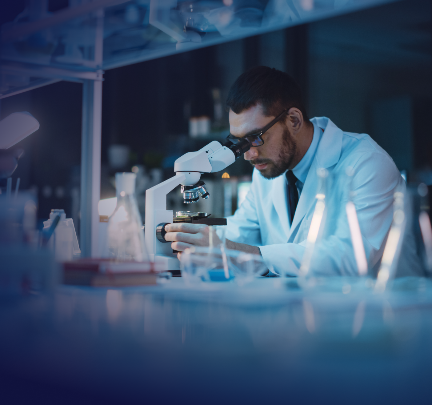 research scientist looking at microscope