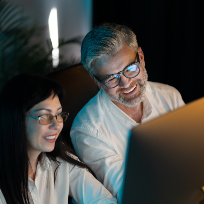 two office workers looking at computer