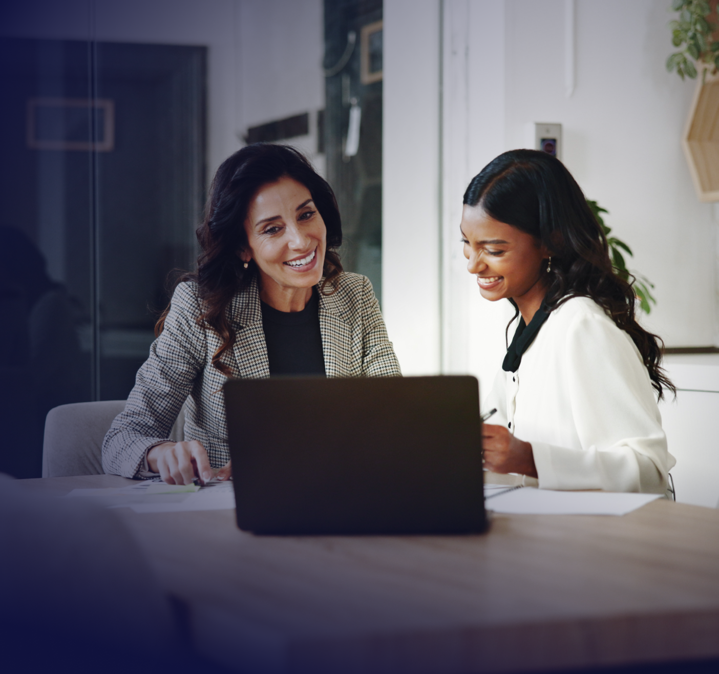 office workers looking at a laptop together