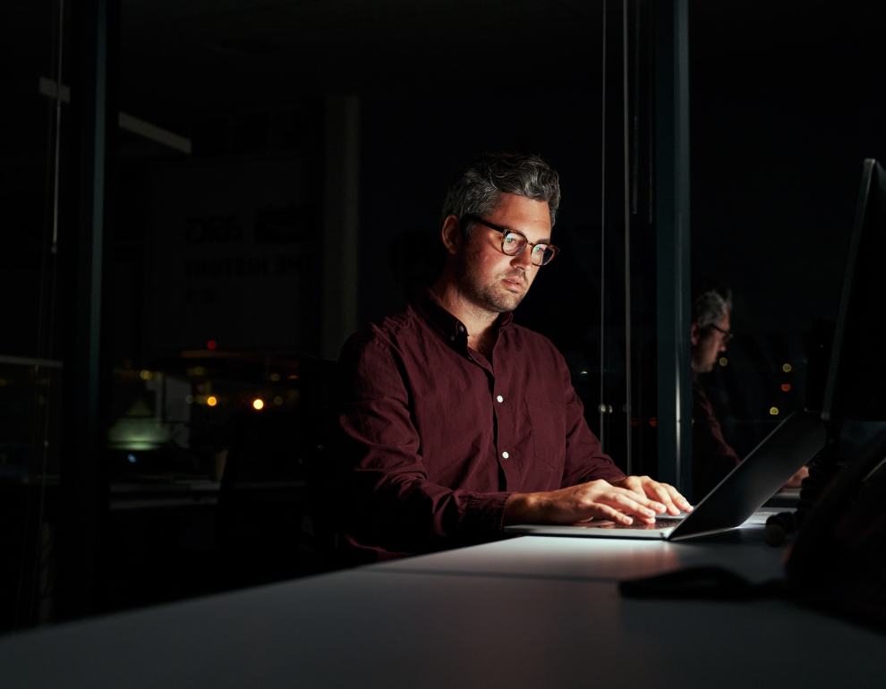 business professional at desk on laptop