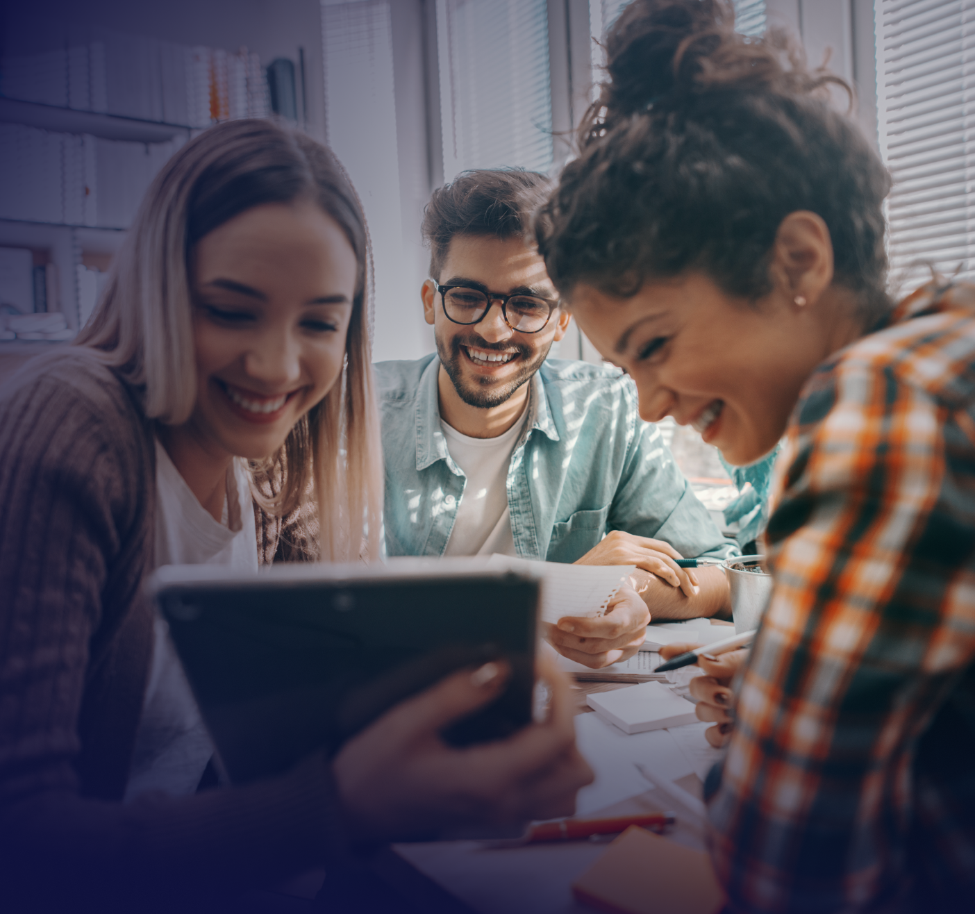 university students looking at tablet