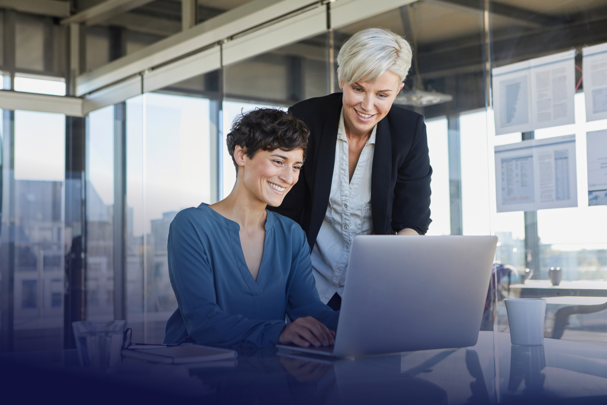 Office workers looking at laptop