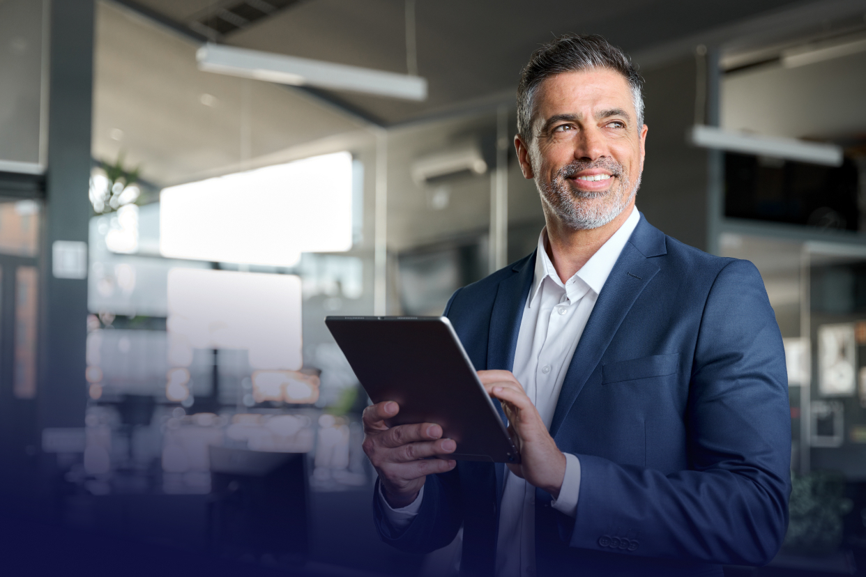 Office worker smiling while holding tablet