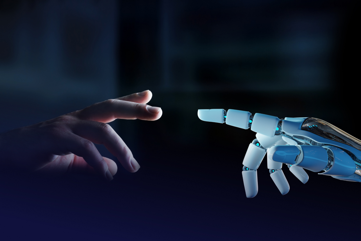 Human hand reaching out to robot hand