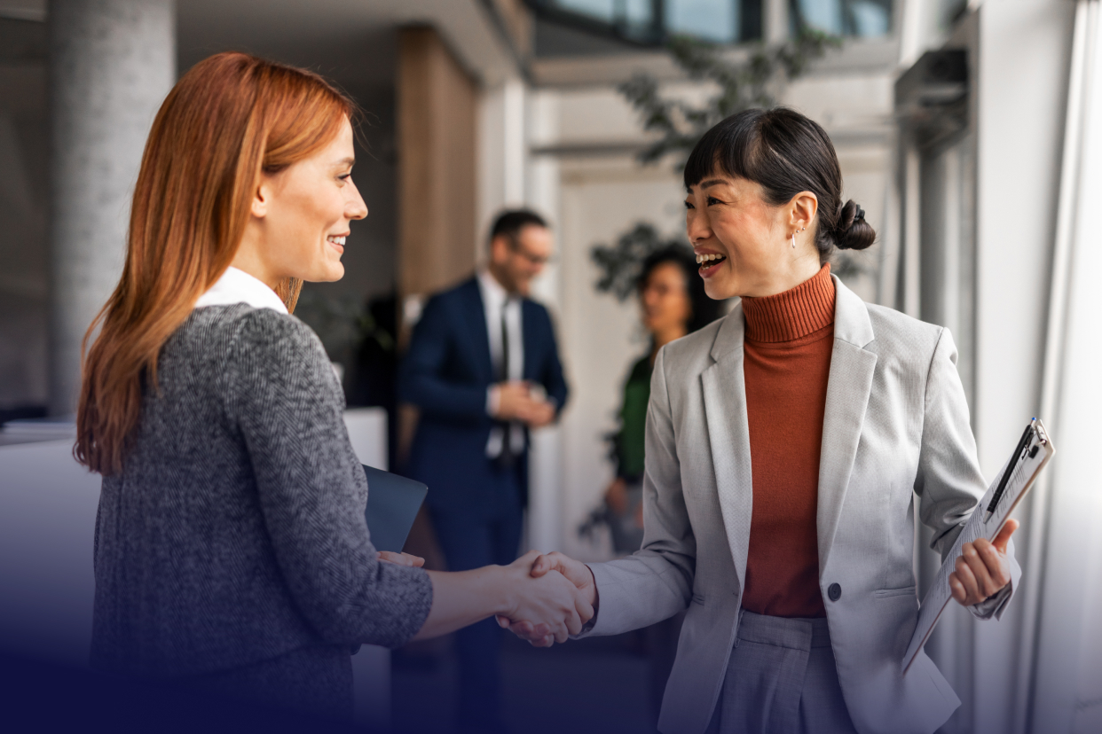 Two professional women shaking hands
