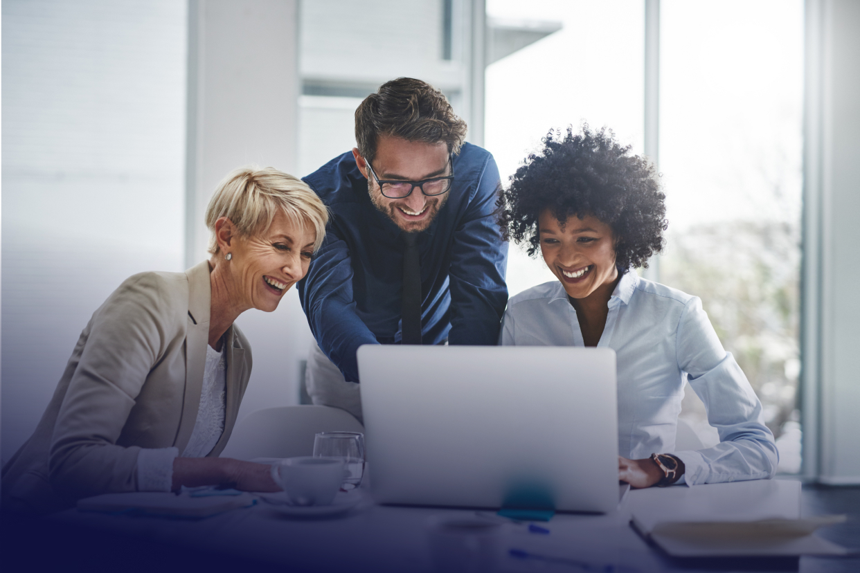 Office workers gathered around laptop