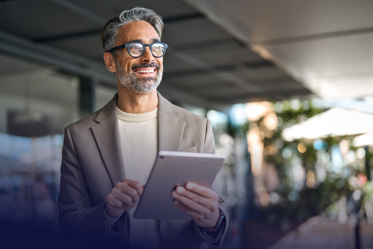 Professional worker smiling while holding tablet