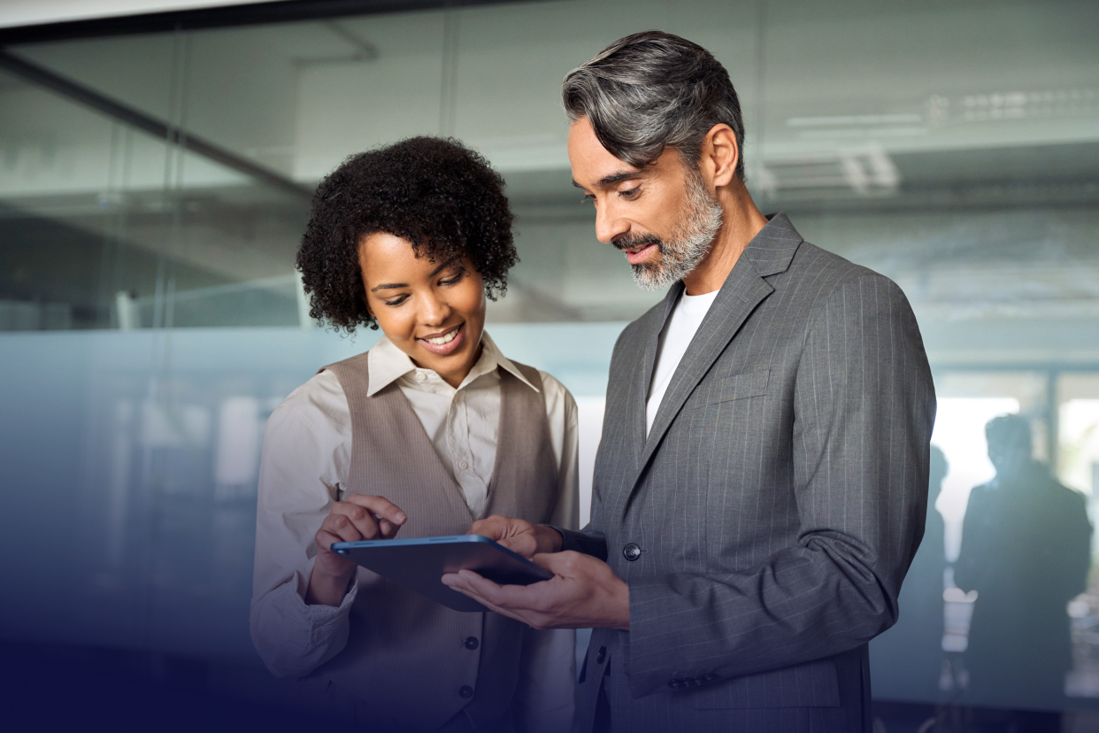 Two office workers looking at a tablet