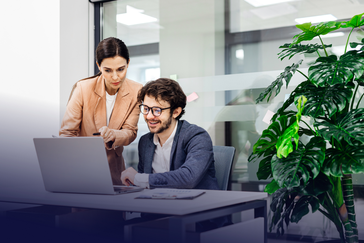 Professionals working at desk with laptop