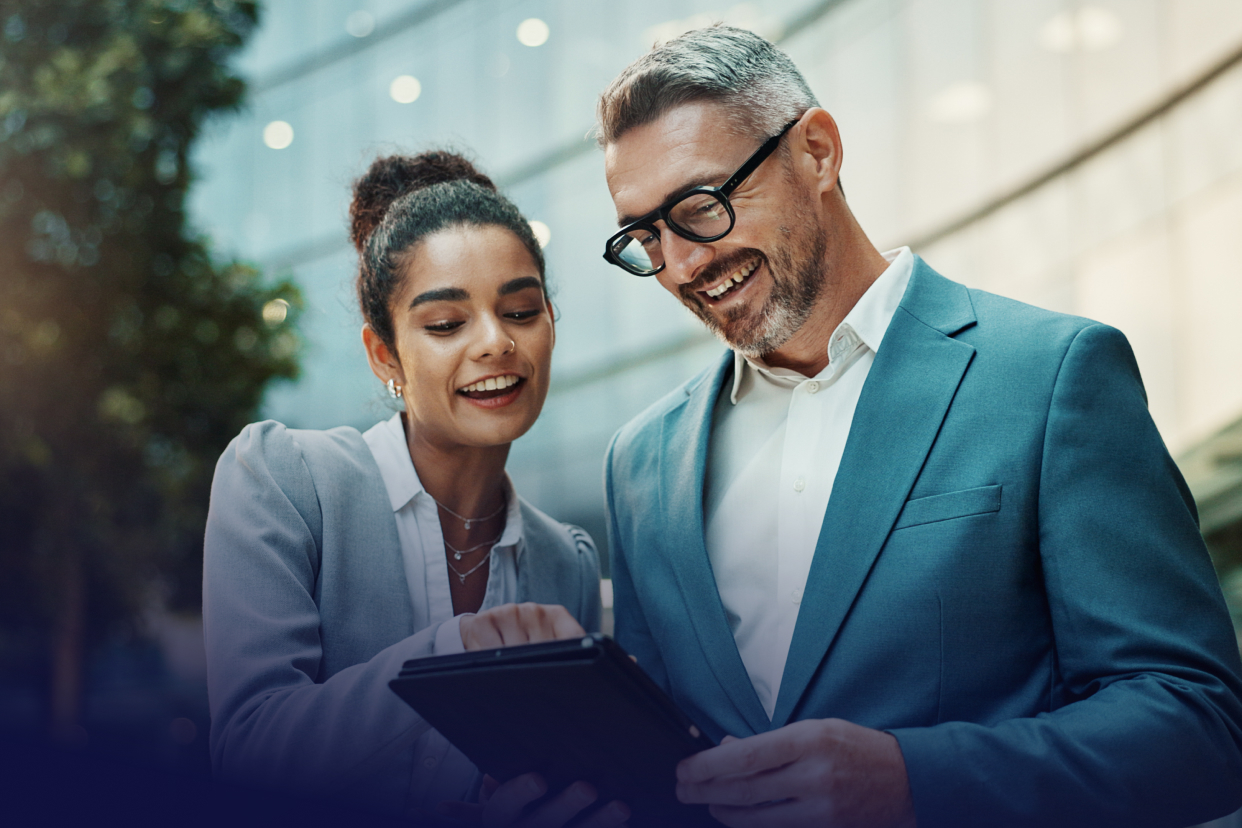 Two professional workers looking at tablet