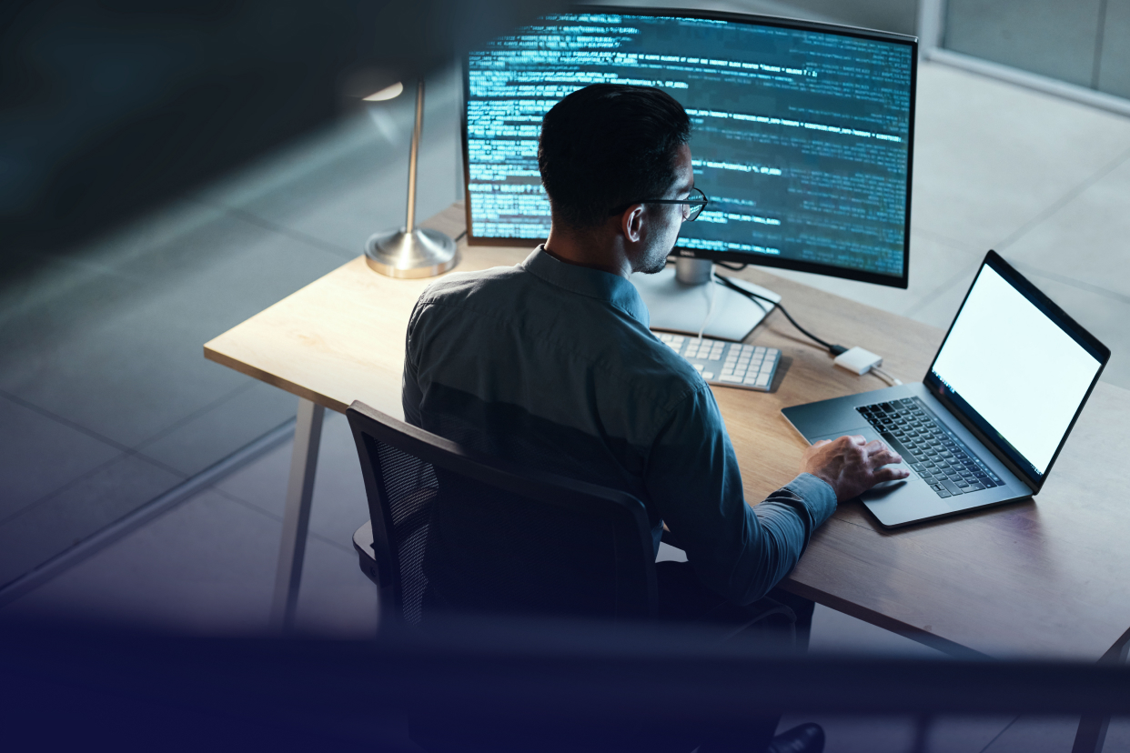 Developer working on computer at desk